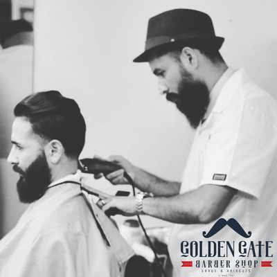 A man getting his beard trimmed by a barber